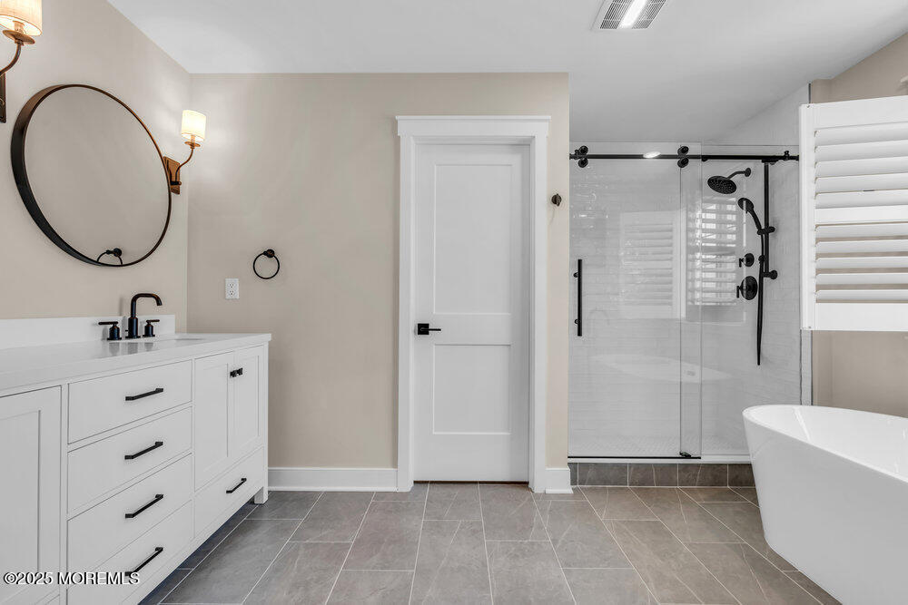 3028 Quail Rdg Boulevard, Unit 606 Farmingdale, NJ 07727 - Photo 52 of 82 a bathroom with a double vanity sink mirror and bathtub