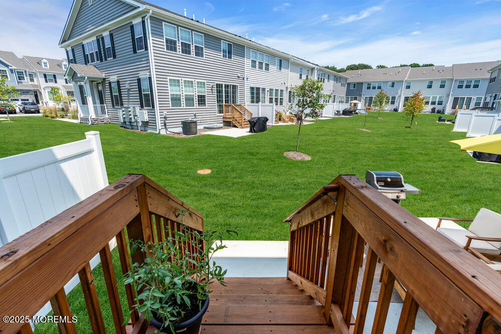 3028 Quail Rdg Boulevard, Unit 606 Farmingdale, NJ 07727 - Photo 57 of 82 a view of a house with backyard porch and sitting area