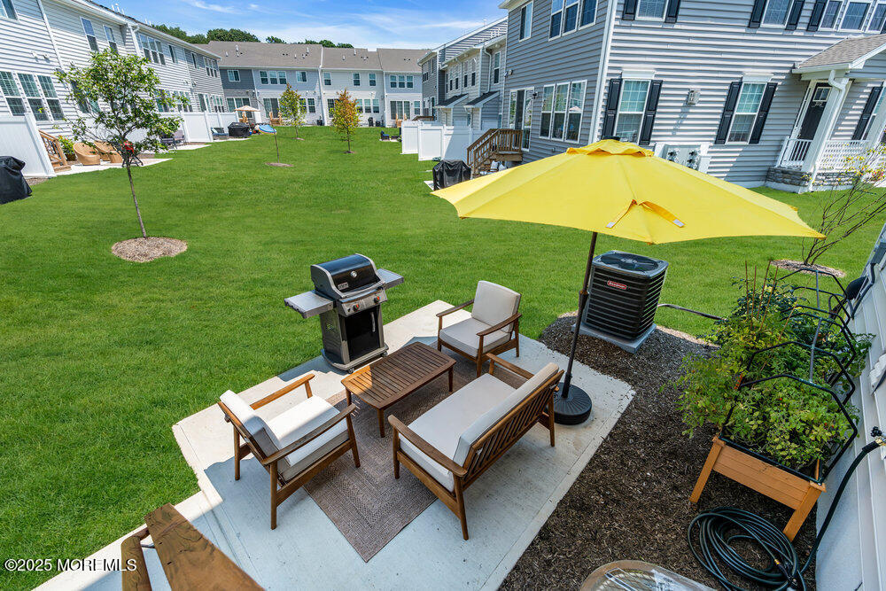 3028 Quail Rdg Boulevard, Unit 606 Farmingdale, NJ 07727 - Photo 59 of 82 a view of a swimming pool and lounge chairs in back yard of the house