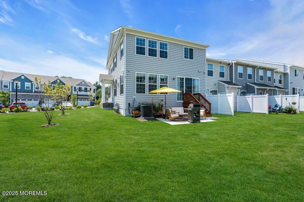3028 Quail Rdg Boulevard, Unit 606 Farmingdale, NJ 07727 - Photo 61 of 82 a front view of a house with a yard fire pit and outdoor seating