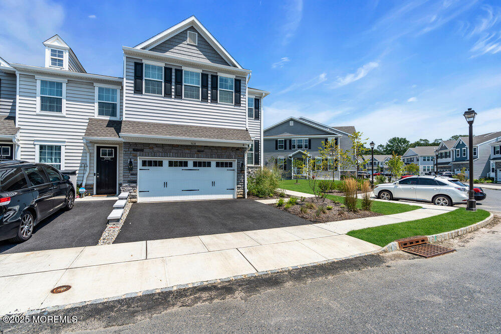 3028 Quail Rdg Boulevard, Unit 606 Farmingdale, NJ 07727 - Photo 65 of 82 a front view of a house with a yard and garage