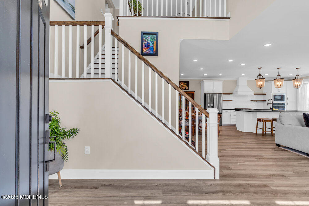 3028 Quail Rdg Boulevard, Unit 606 Farmingdale, NJ 07727 - Photo 7 of 82 a view of a hallway with wooden floor and entryway