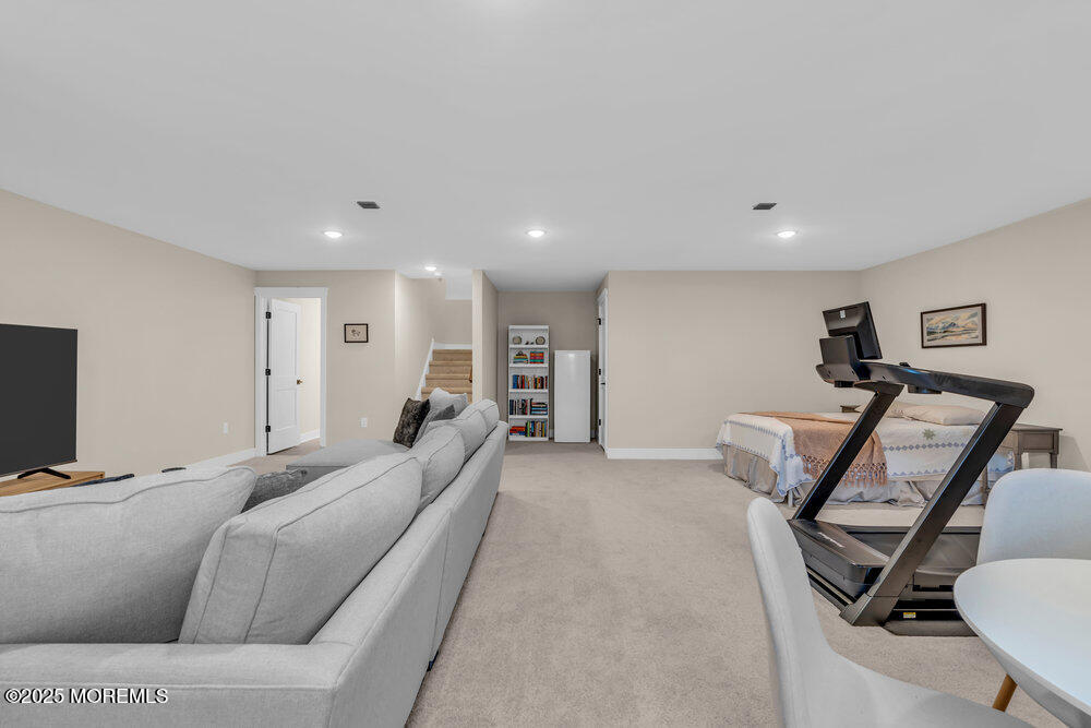3028 Quail Rdg Boulevard, Unit 606 Farmingdale, NJ 07727 - Photo 72 of 82 a living room with furniture a flat screen tv and a couch
