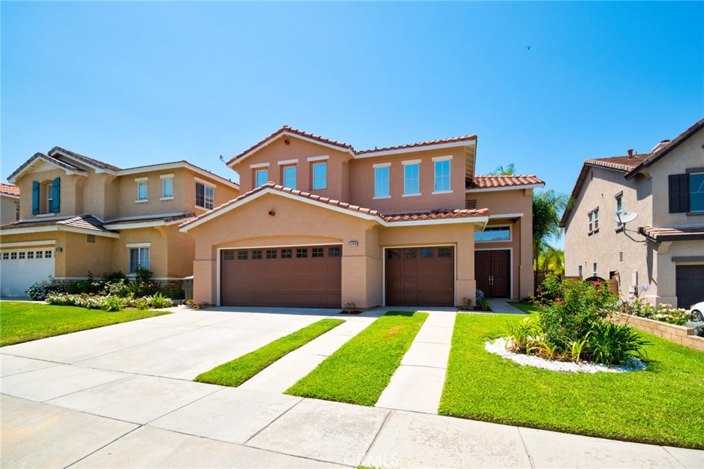 4340 Butler National Road Corona, CA 92883 - Photo 1 of 1 a front view of a house with a yard and garage