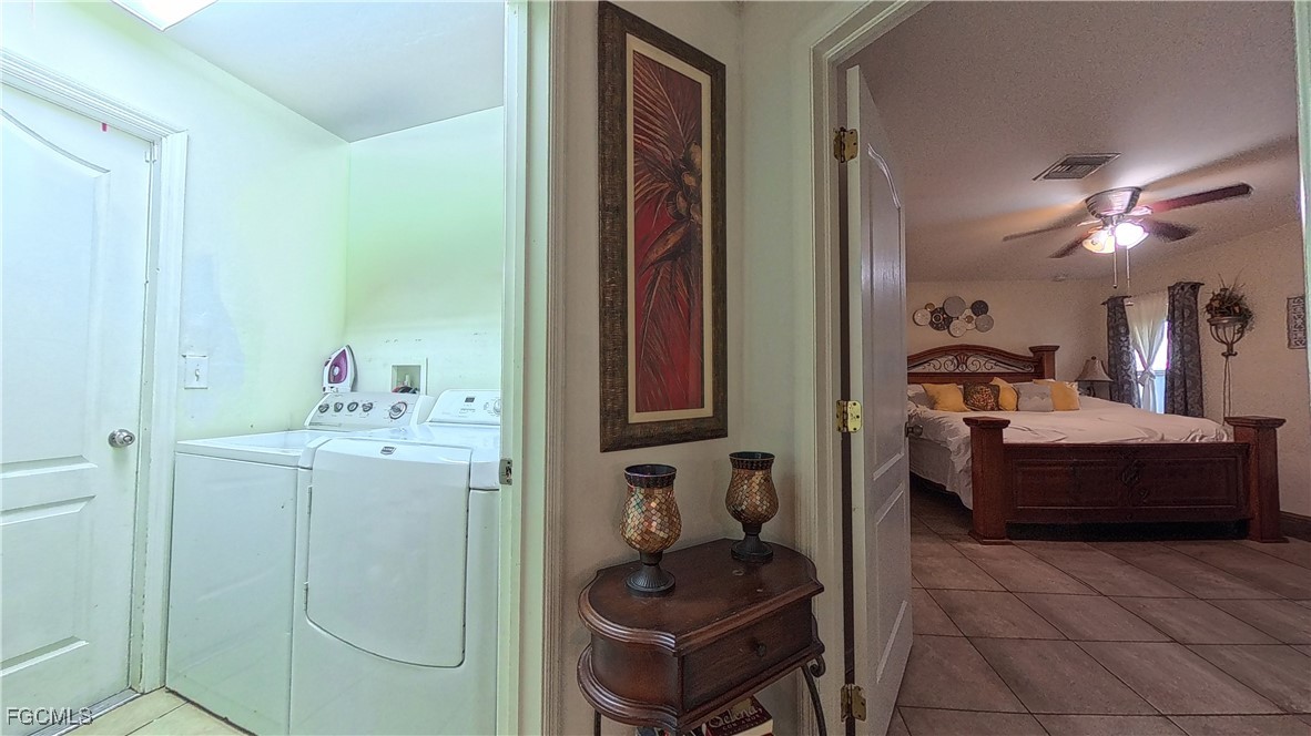 3003 25th Street West Lehigh Acres, FL 33971 - Photo 12 of 25 a en suite bathroom with a tub sink and mirror