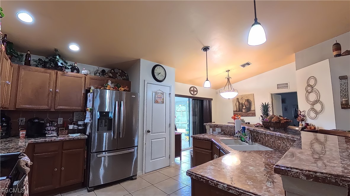 3003 25th Street West Lehigh Acres, FL 33971 - Photo 17 of 25 a kitchen with stainless steel appliances granite countertop a refrigerator a oven and a sink