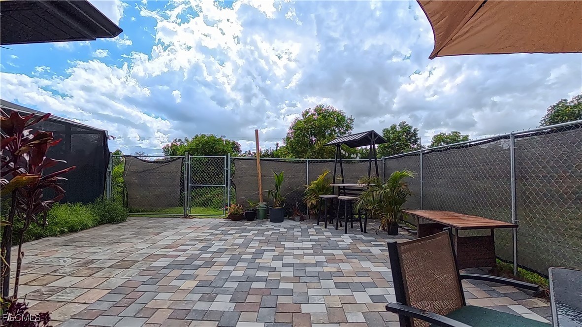 3003 25th Street West Lehigh Acres, FL 33971 - Photo 25 of 25 a backyard of a house with table and chairs