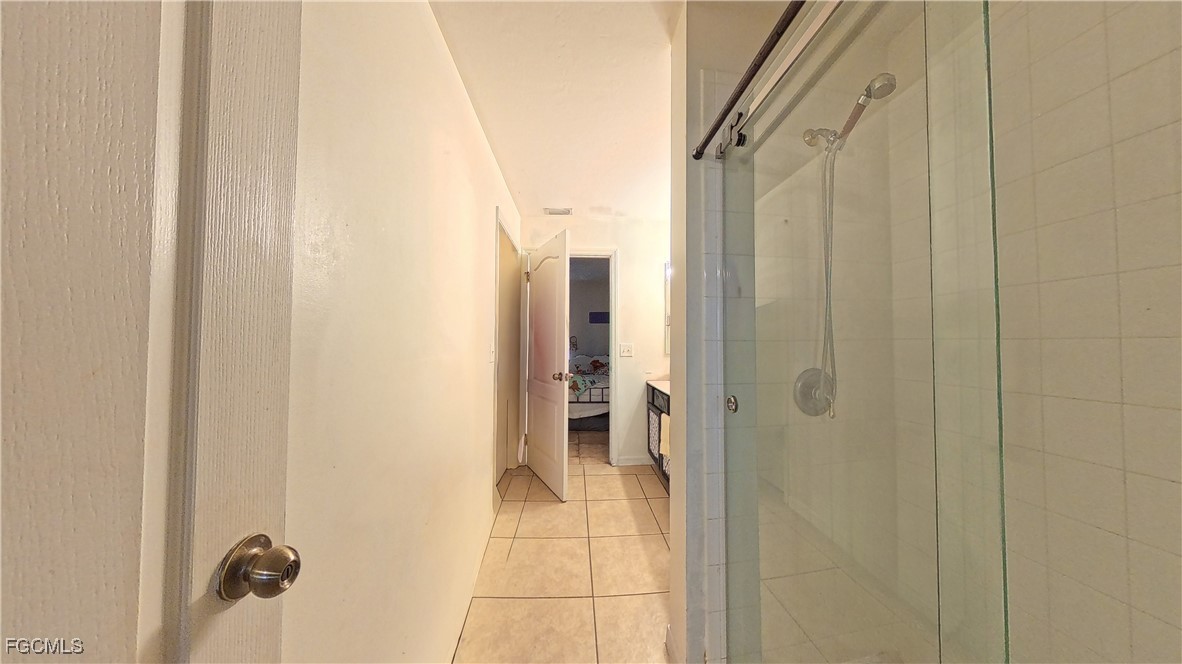 3003 25th Street West Lehigh Acres, FL 33971 - Photo 5 of 25 a bathroom with a glass shower door