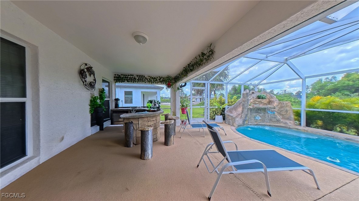 3003 25th Street West Lehigh Acres, FL 33971 - Photo 6 of 25 a view of a patio with a table chairs and a backyard