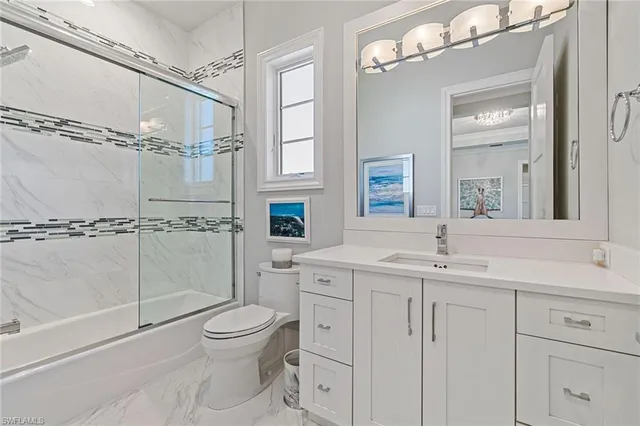 a spacious bedroom with a bed and a chandelier