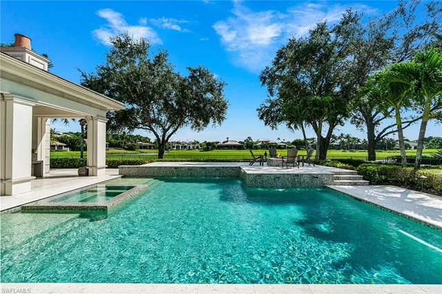 a house view with swimming pool and outdoor seating