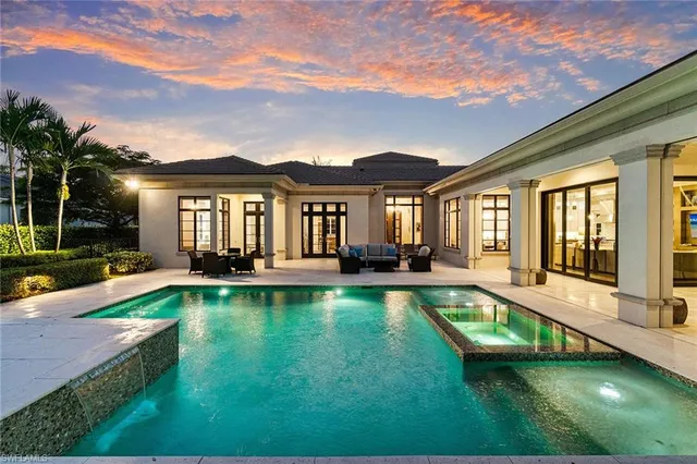 a view of a house with backyard porch and sitting area