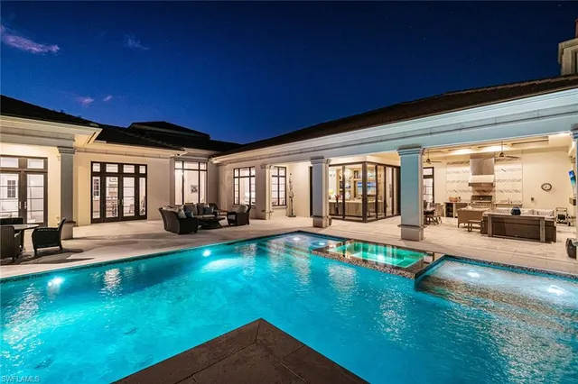 an aerial view of residential houses with outdoor space and lake view