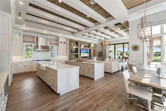 a kitchen with counter top space and wooden floor