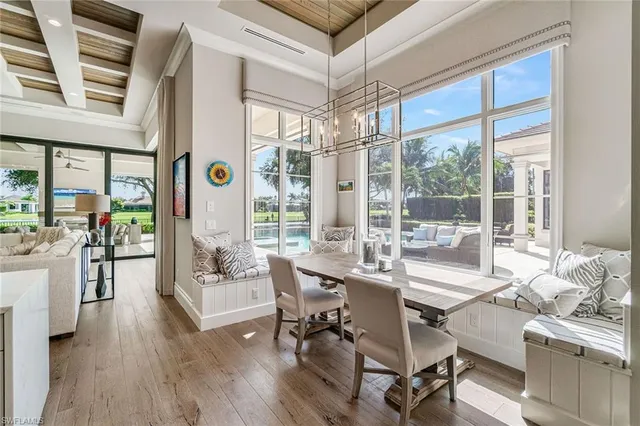 a large kitchen with lots of counter space a sink appliances and dining table