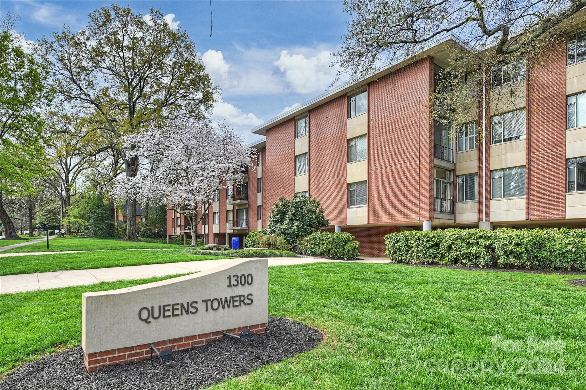 1300 Queens Road, Unit 317 Charlotte, NC 28207 - Photo 1 of 24 a sign on the side of the building