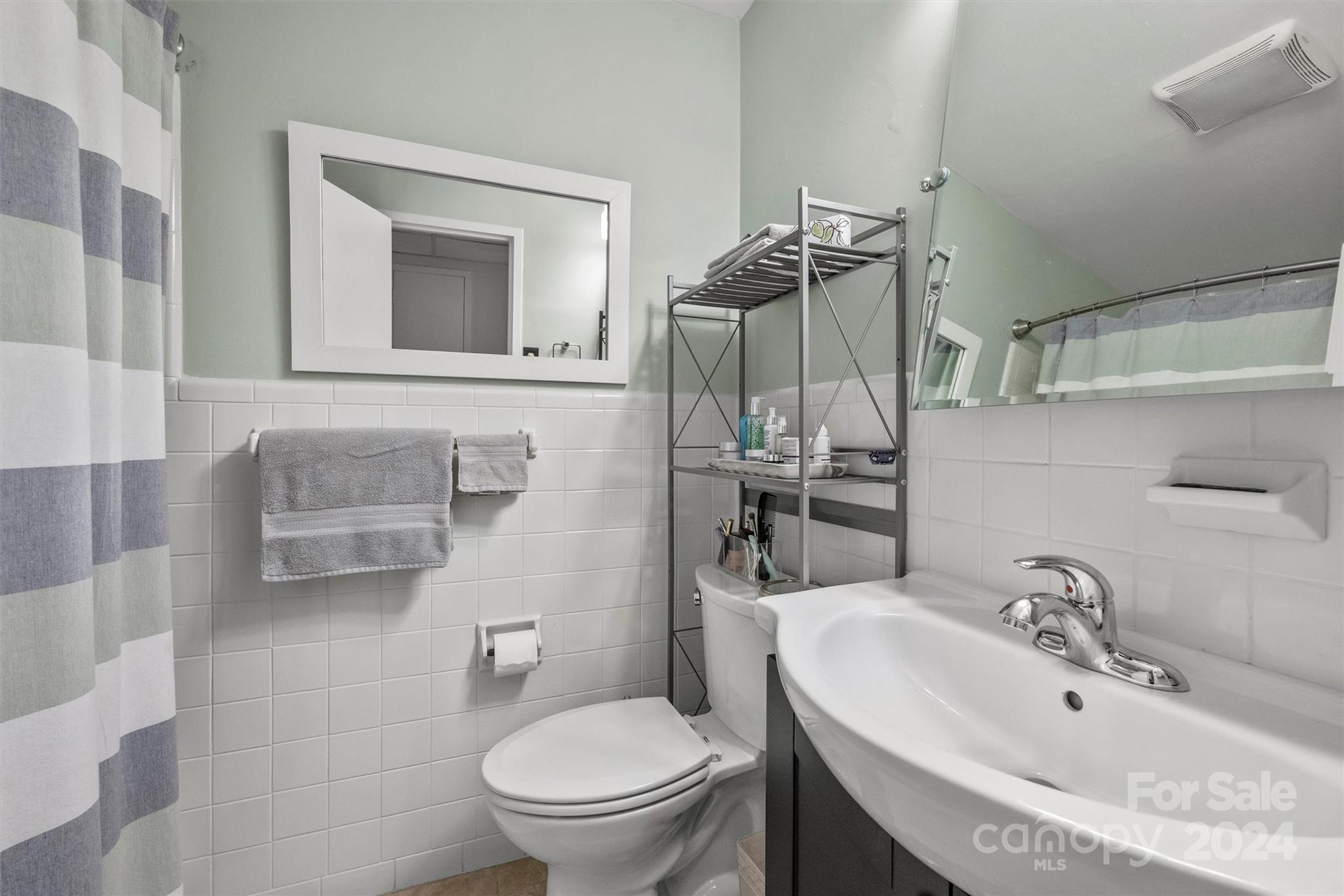 1300 Queens Road, Unit 317 Charlotte, NC 28207 - Photo 11 of 24 a bathroom with a sink toilet and shower