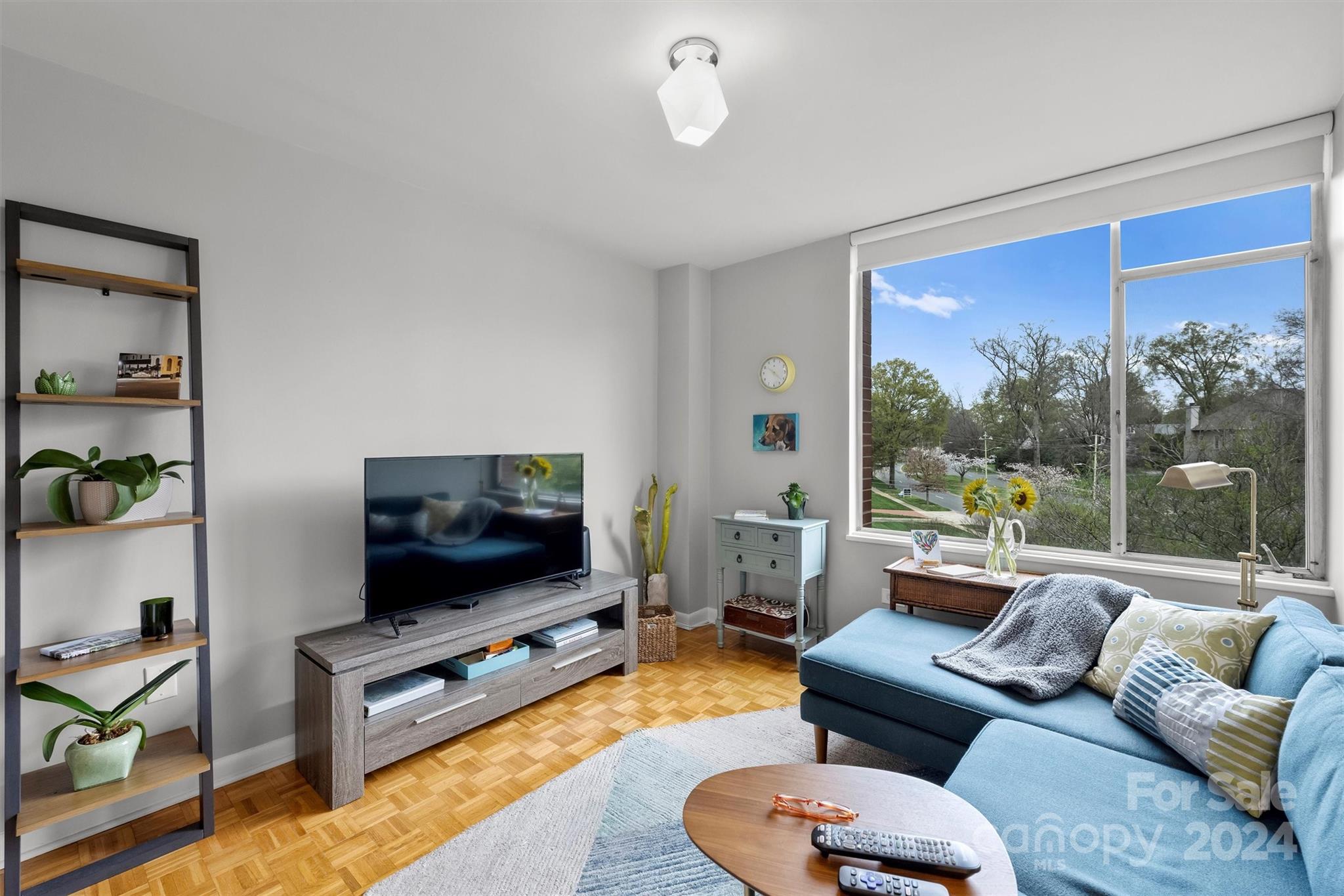 1300 Queens Road, Unit 317 Charlotte, NC 28207 - Photo 13 of 24 a living room with furniture and a flat screen tv