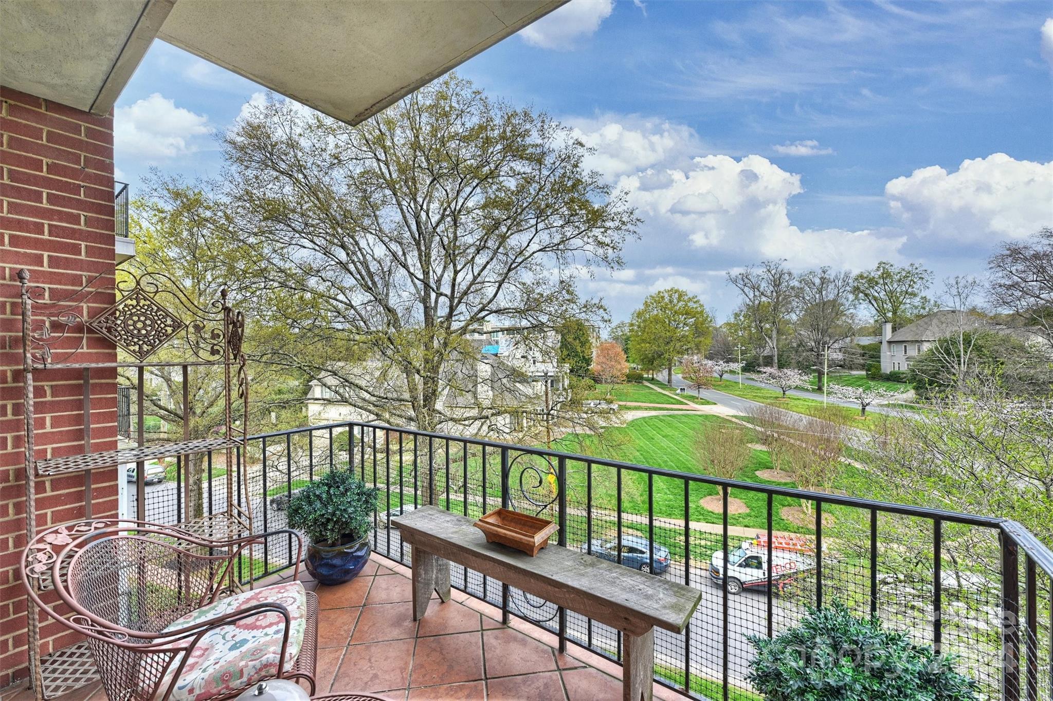 1300 Queens Road, Unit 317 Charlotte, NC 28207 - Photo 19 of 24 a balcony with table and chairs