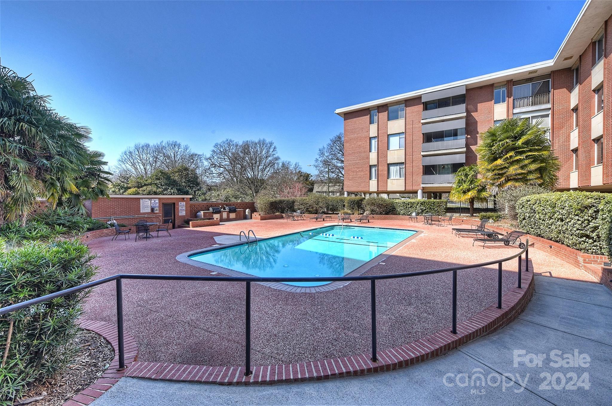 1300 Queens Road, Unit 317 Charlotte, NC 28207 - Photo 20 of 24 a view of a swimming pool with a lounge chairs