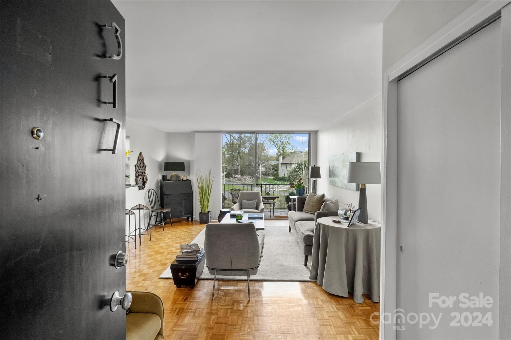 1300 Queens Road, Unit 317 Charlotte, NC 28207 - Photo 2 of 24 a living room with furniture large window and a table
