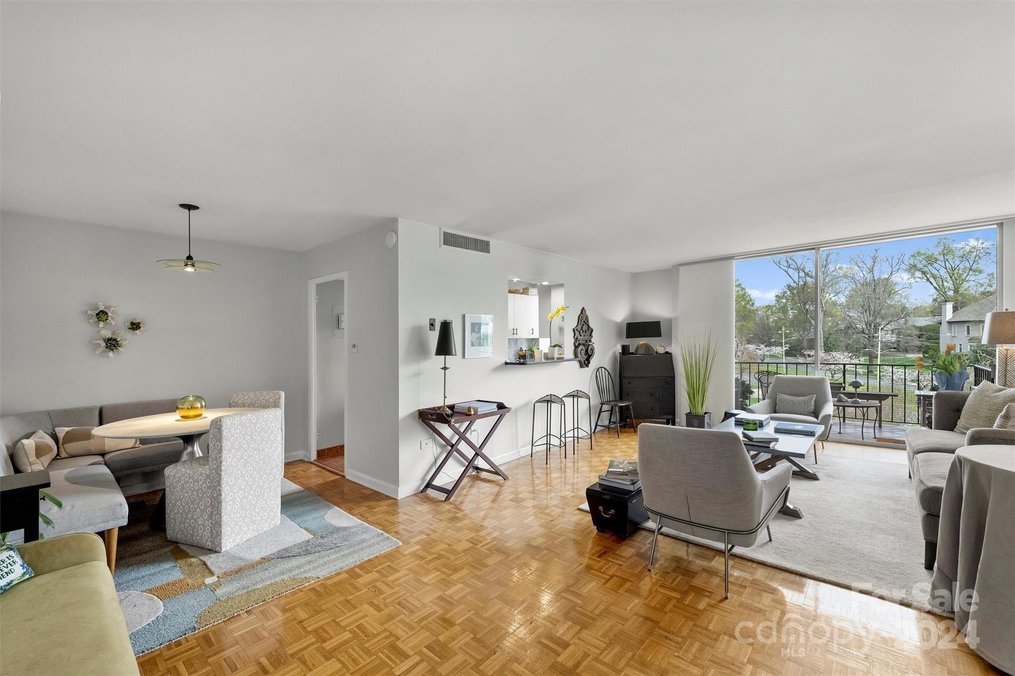 1300 Queens Road, Unit 317 Charlotte, NC 28207 - Photo 5 of 24 a living room with furniture large window and a table