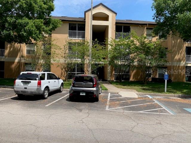 Undisclosed Address Orlando, FL 32819 - Photo 1 of 9 a car parked in front of a brick house