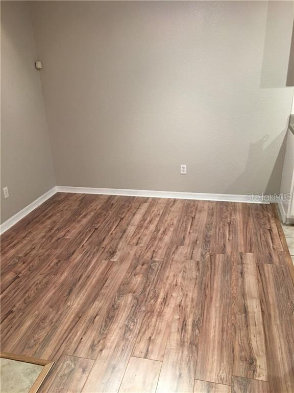 Undisclosed Address Orlando, FL 32819 - Photo 4 of 9 a view of wooden floor in a room