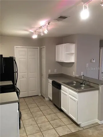 a kitchen with a stove and a refrigerator