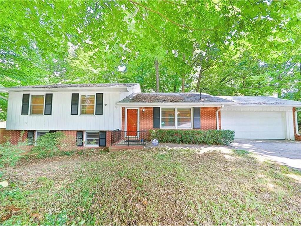 3463 Aztec Road Atlanta, GA 30340 - Photo 1 of 1 a view of a yard in front of a house with large windows