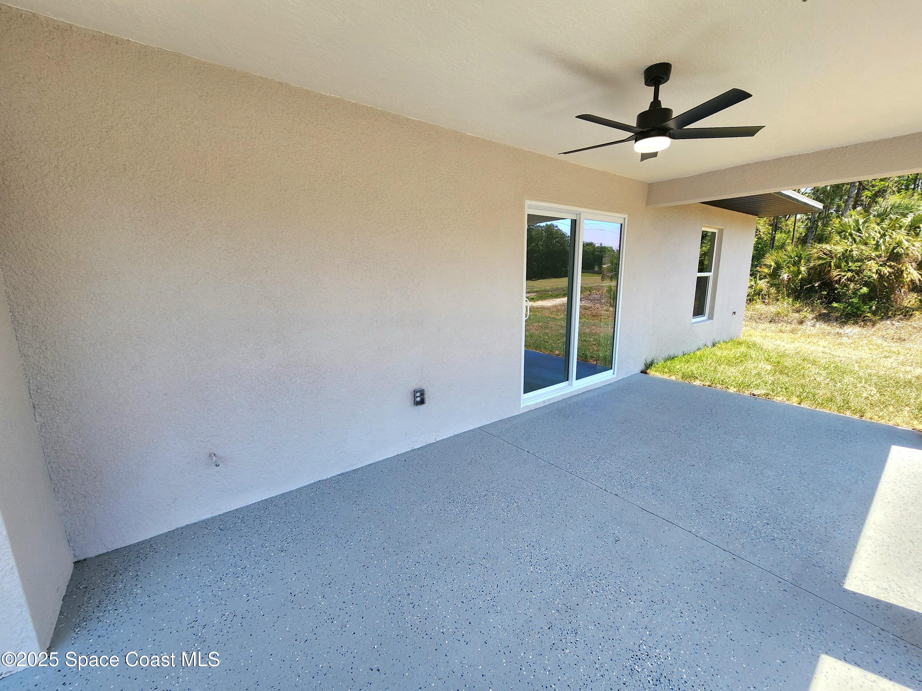 710 Bryant Road Palm Bay, FL 32908 - Photo 25 of 26 a view of a livingroom with a ceiling fan and window