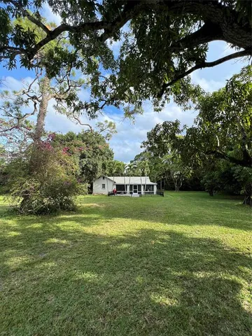 a view of a grassy field with trees