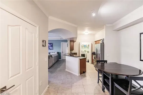 a large kitchen with a table and chairs