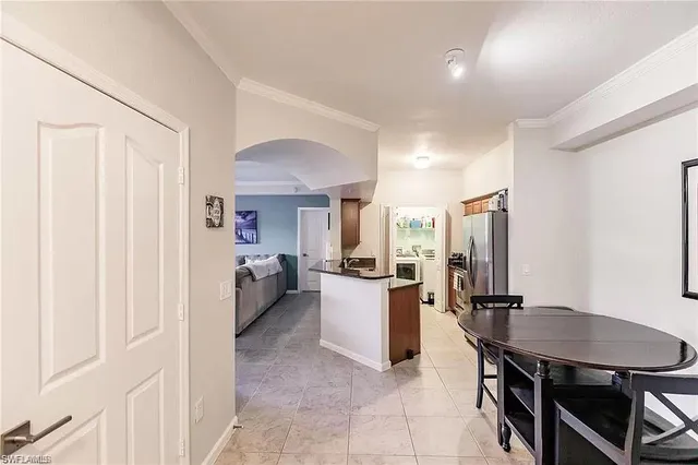 a large kitchen with a table and chairs