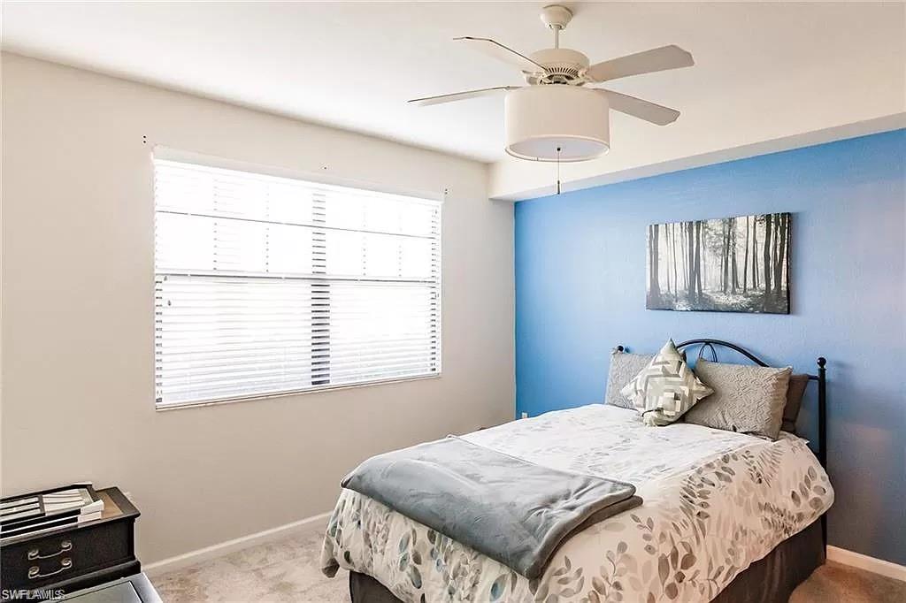 13010 Positano Circle, Unit 101 Naples, FL 34105 - Photo 15 of 29 a bedroom with a bed and a window