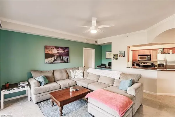 a living room with furniture ceiling fan and a rug