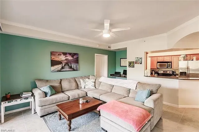 a living room with furniture ceiling fan and a rug
