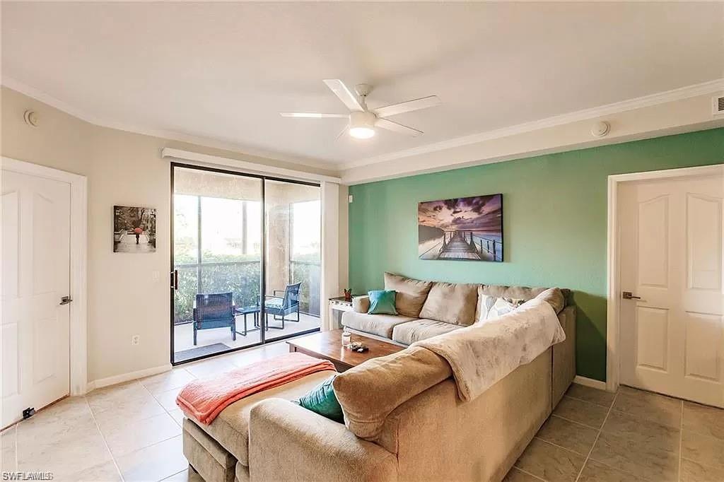 13010 Positano Circle, Unit 101 Naples, FL 34105 - Photo 3 of 29 a bedroom with a bed and a couch