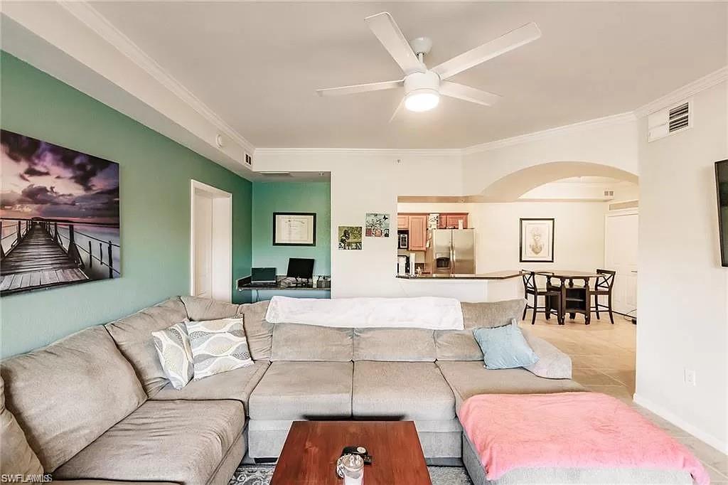 13010 Positano Circle, Unit 101 Naples, FL 34105 - Photo 6 of 29 a living room with furniture and wooden floor