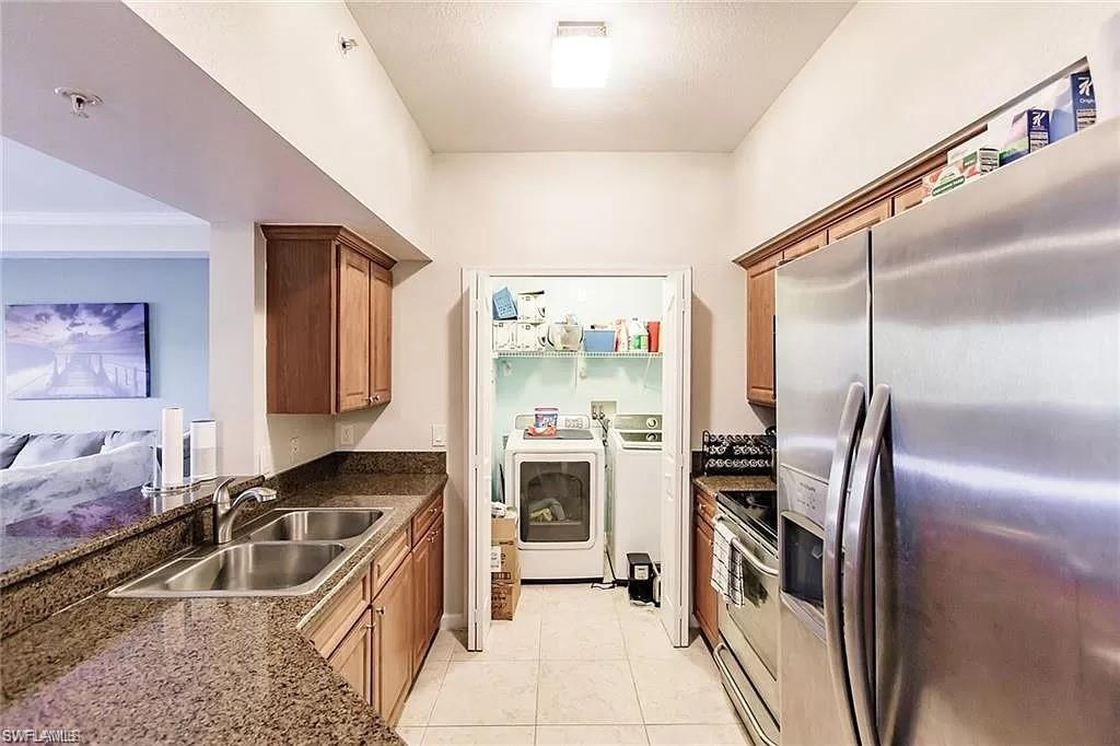 13010 Positano Circle, Unit 101 Naples, FL 34105 - Photo 7 of 29 a kitchen with a stove a sink and a refrigerator