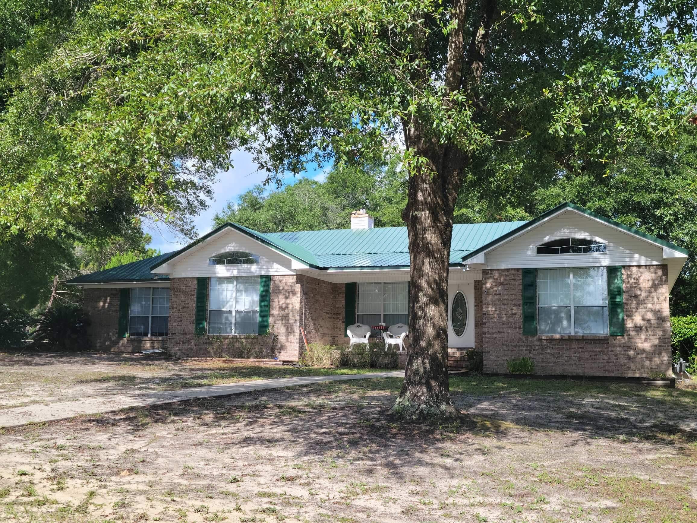 45 Hidden Lakes Trail DeFuniak Springs, FL 32433 - Photo 1 of 39 a front view of a house with garden