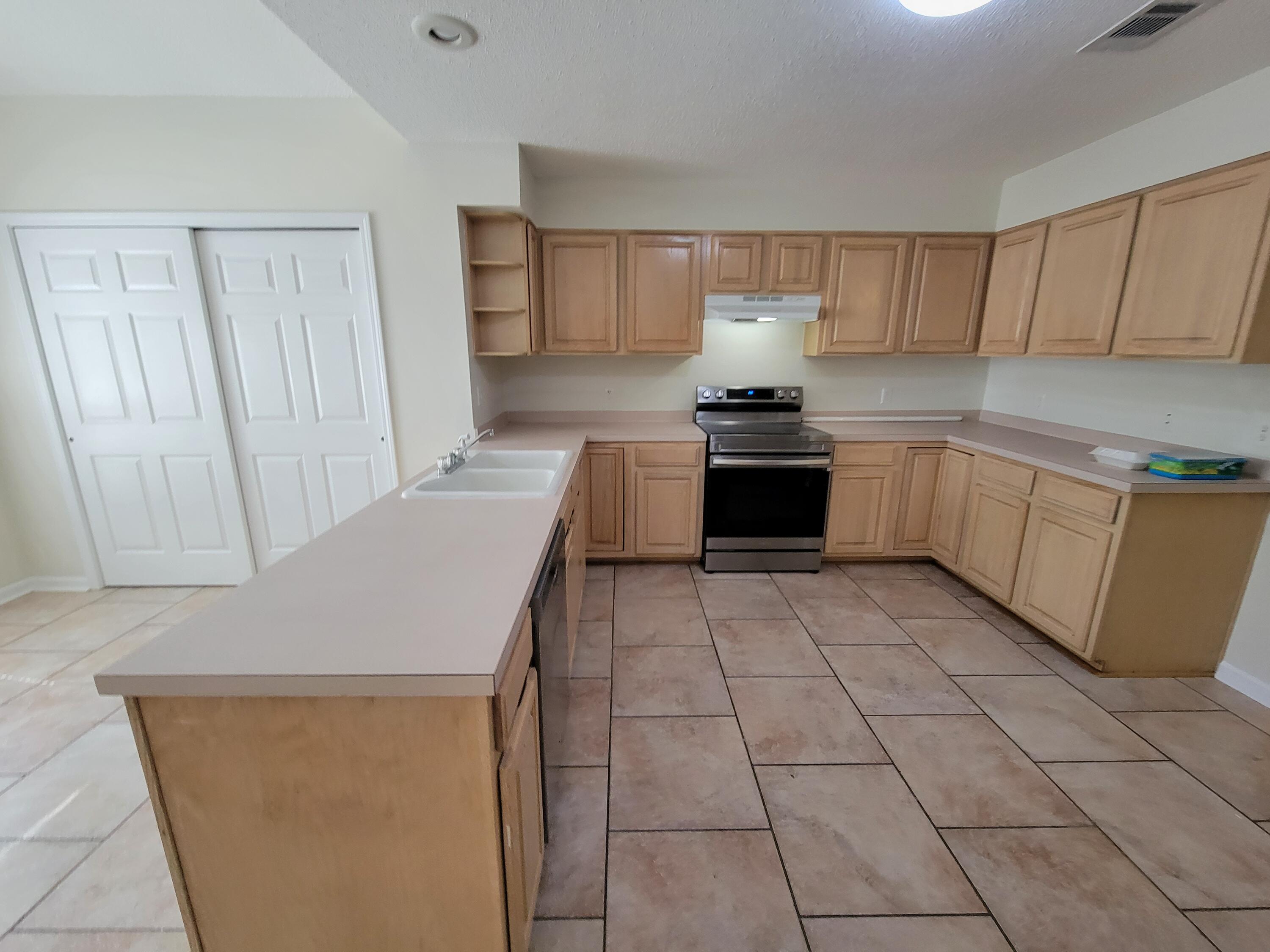 45 Hidden Lakes Trail DeFuniak Springs, FL 32433 - Photo 11 of 39 a kitchen with a sink and a stove top oven