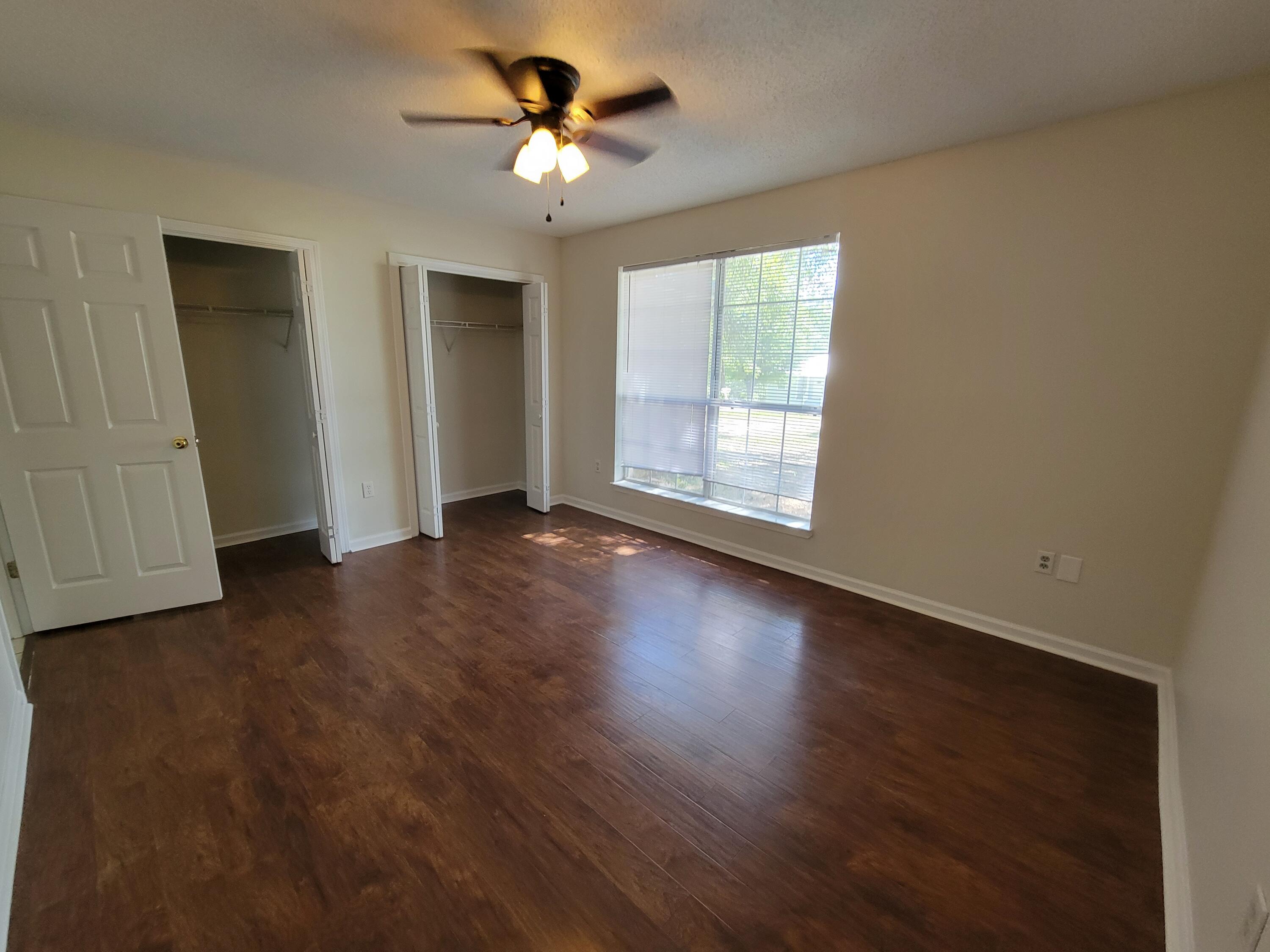 45 Hidden Lakes Trail DeFuniak Springs, FL 32433 - Photo 17 of 39 wooden floor in an empty room with a window