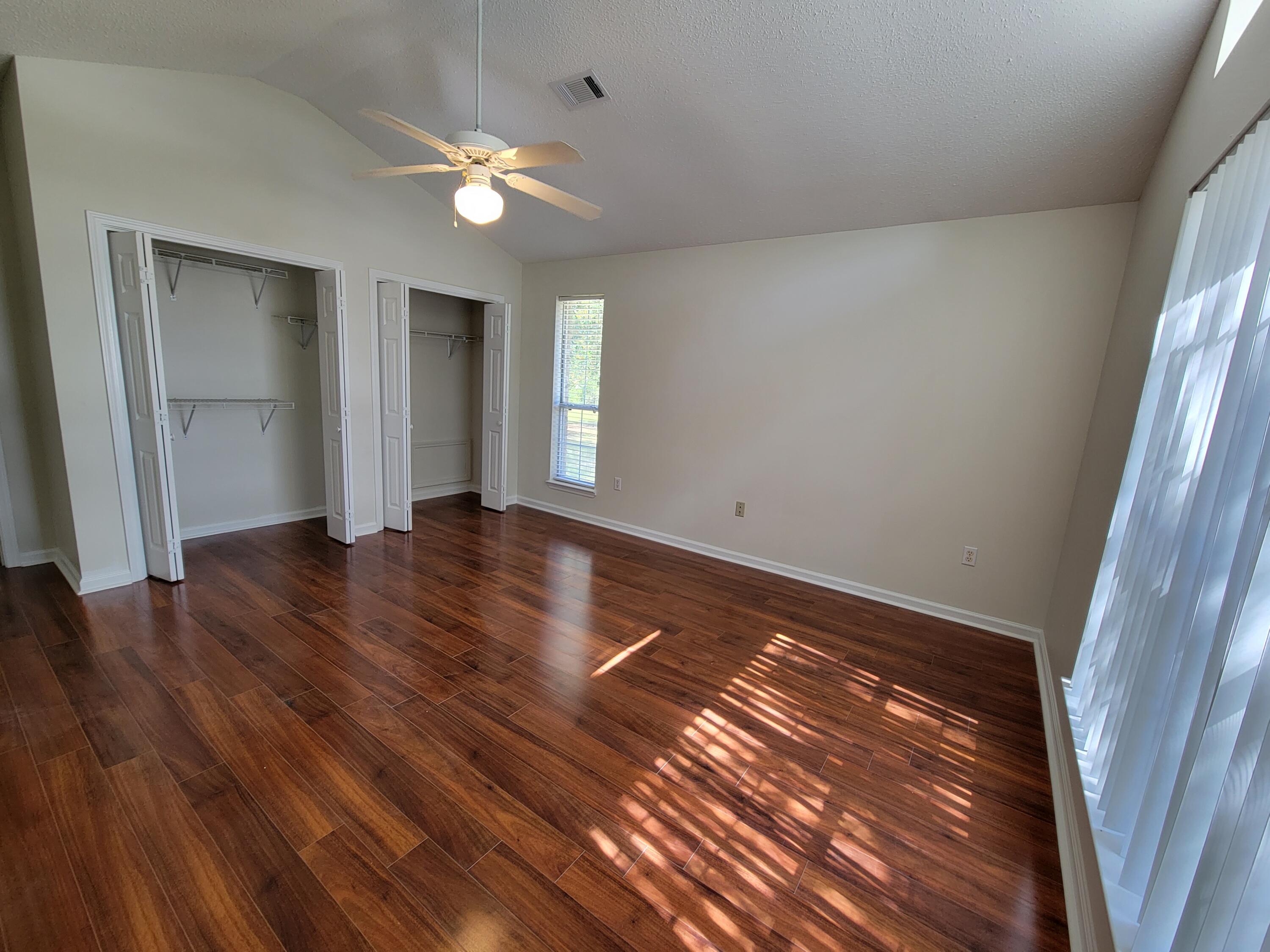 45 Hidden Lakes Trail DeFuniak Springs, FL 32433 - Photo 21 of 39 a view of an empty room with wooden floor and a window