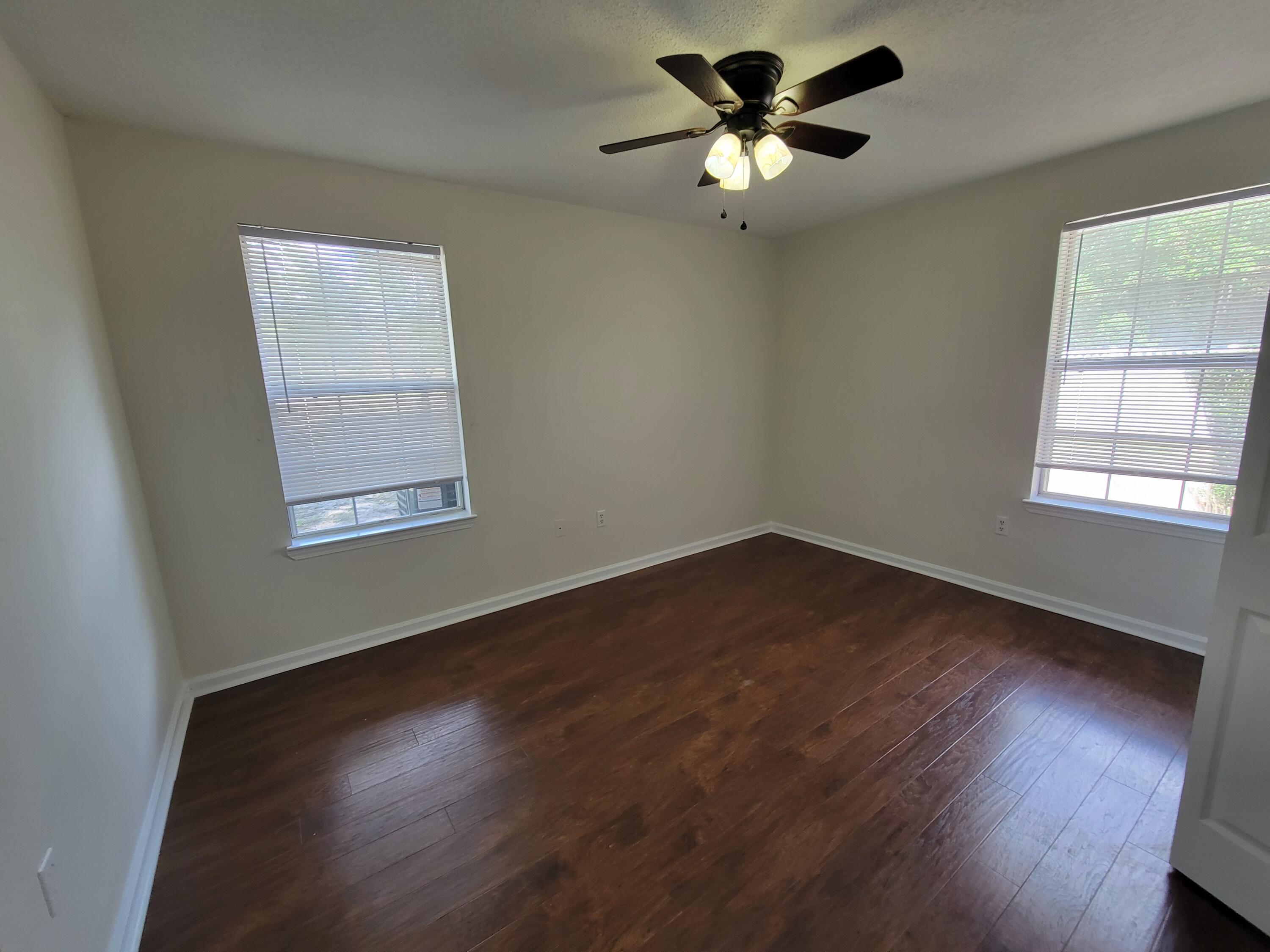 45 Hidden Lakes Trail DeFuniak Springs, FL 32433 - Photo 23 of 39 a view of an empty room with wooden floor and a window