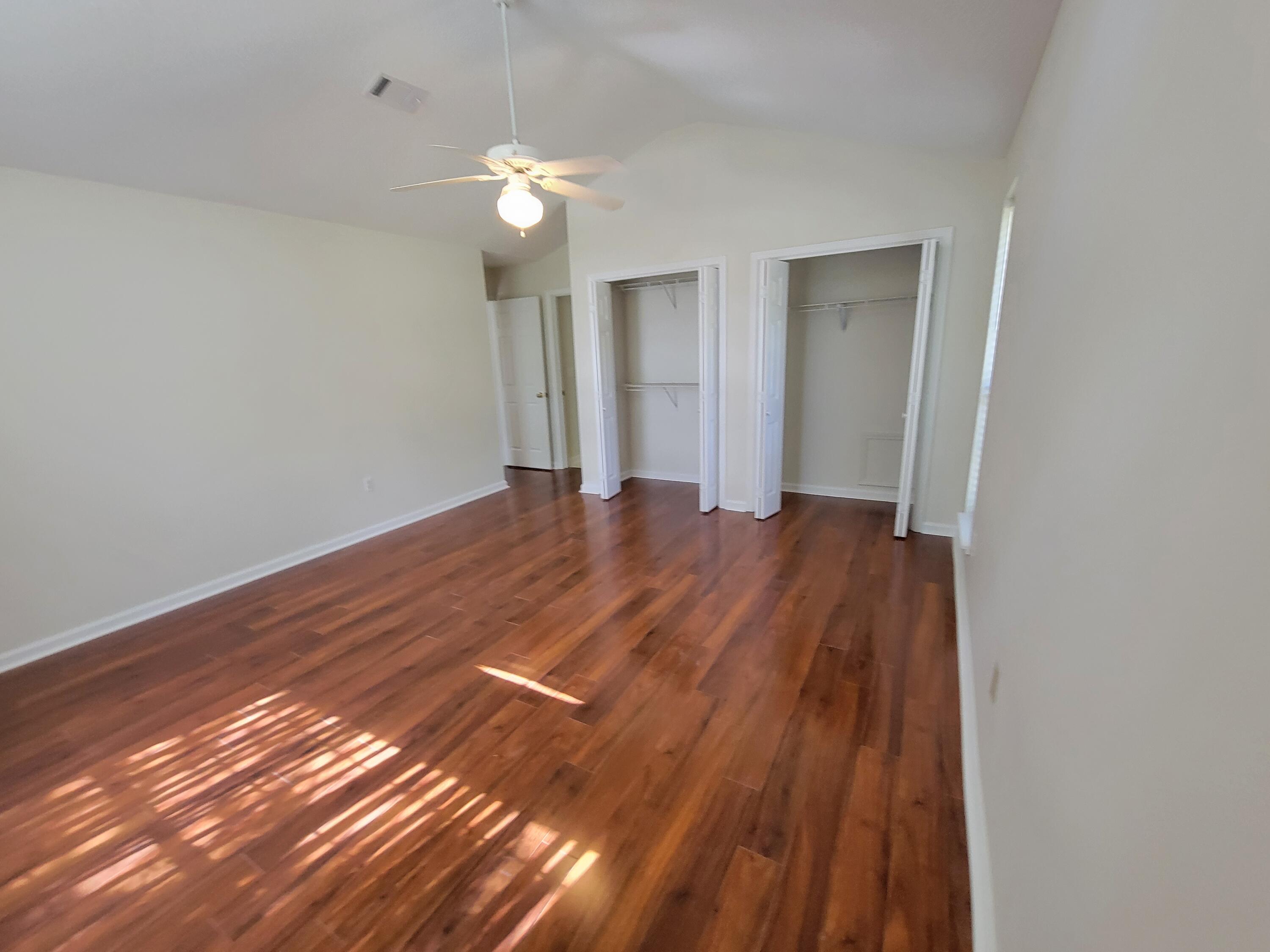 45 Hidden Lakes Trail DeFuniak Springs, FL 32433 - Photo 24 of 39 a view of an empty room with wooden floor