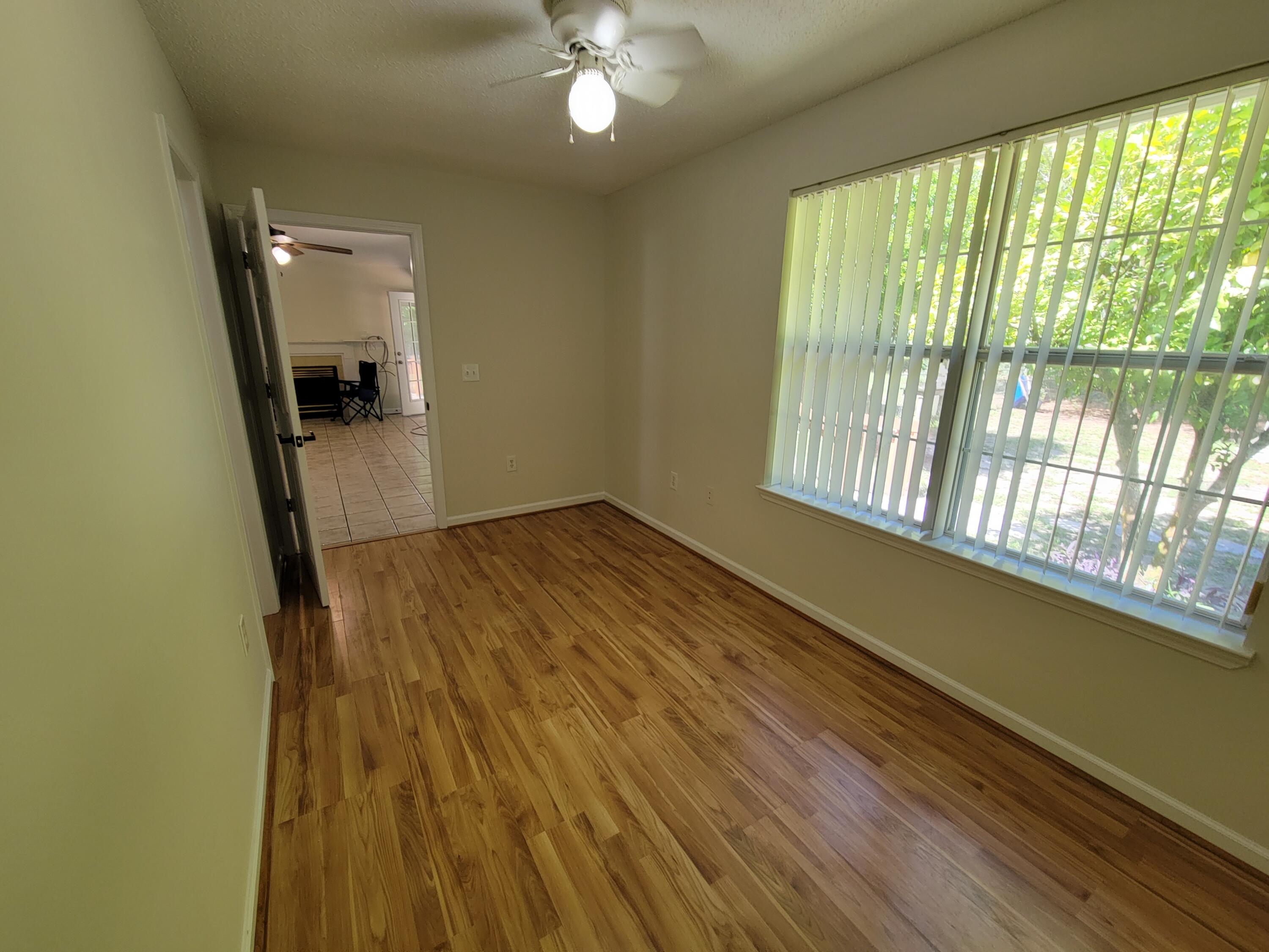 45 Hidden Lakes Trail DeFuniak Springs, FL 32433 - Photo 25 of 39 a view of a room with wooden floor and a window