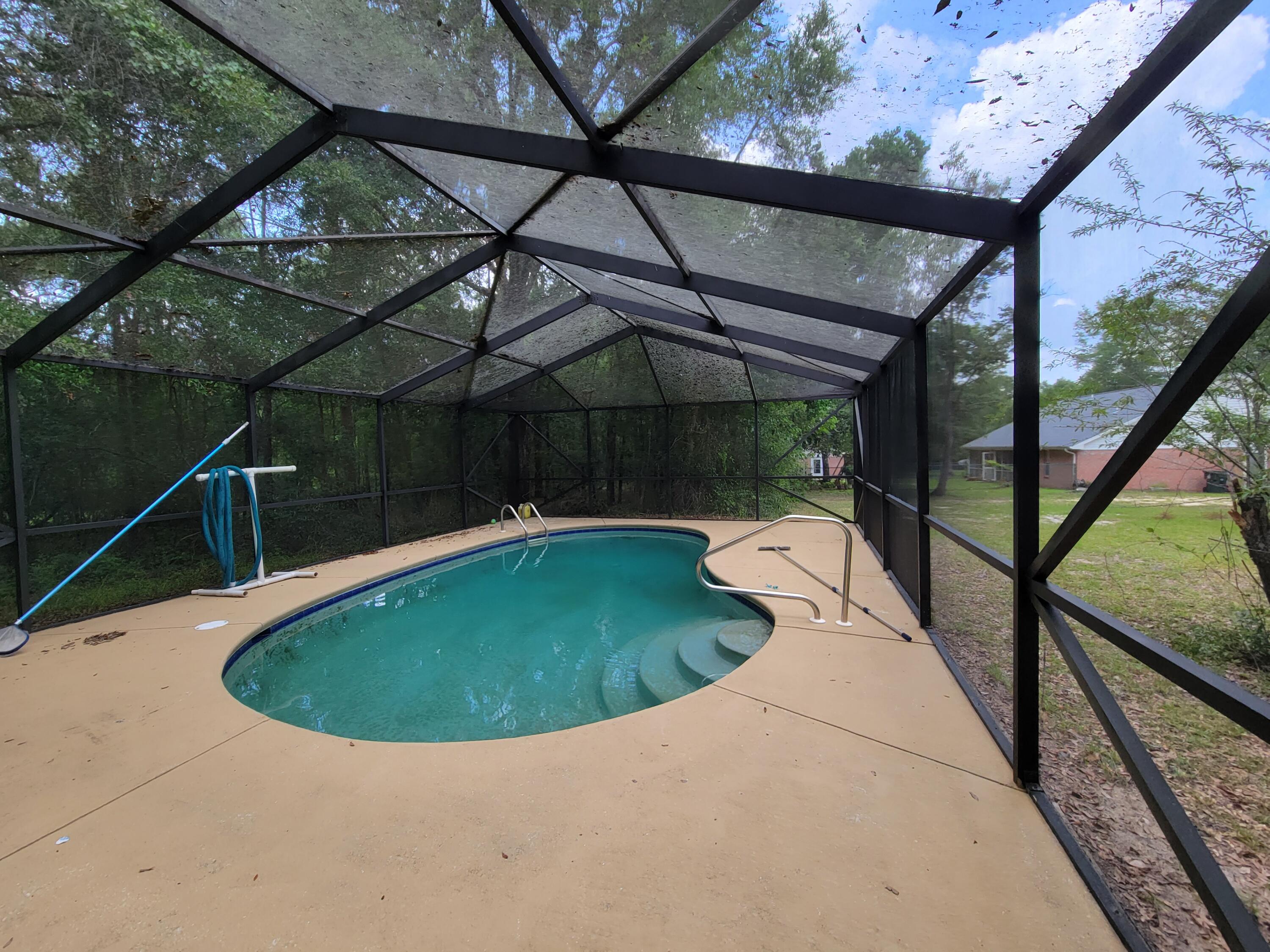 45 Hidden Lakes Trail DeFuniak Springs, FL 32433 - Photo 3 of 39 a view of a swimming pool with a patio and yard