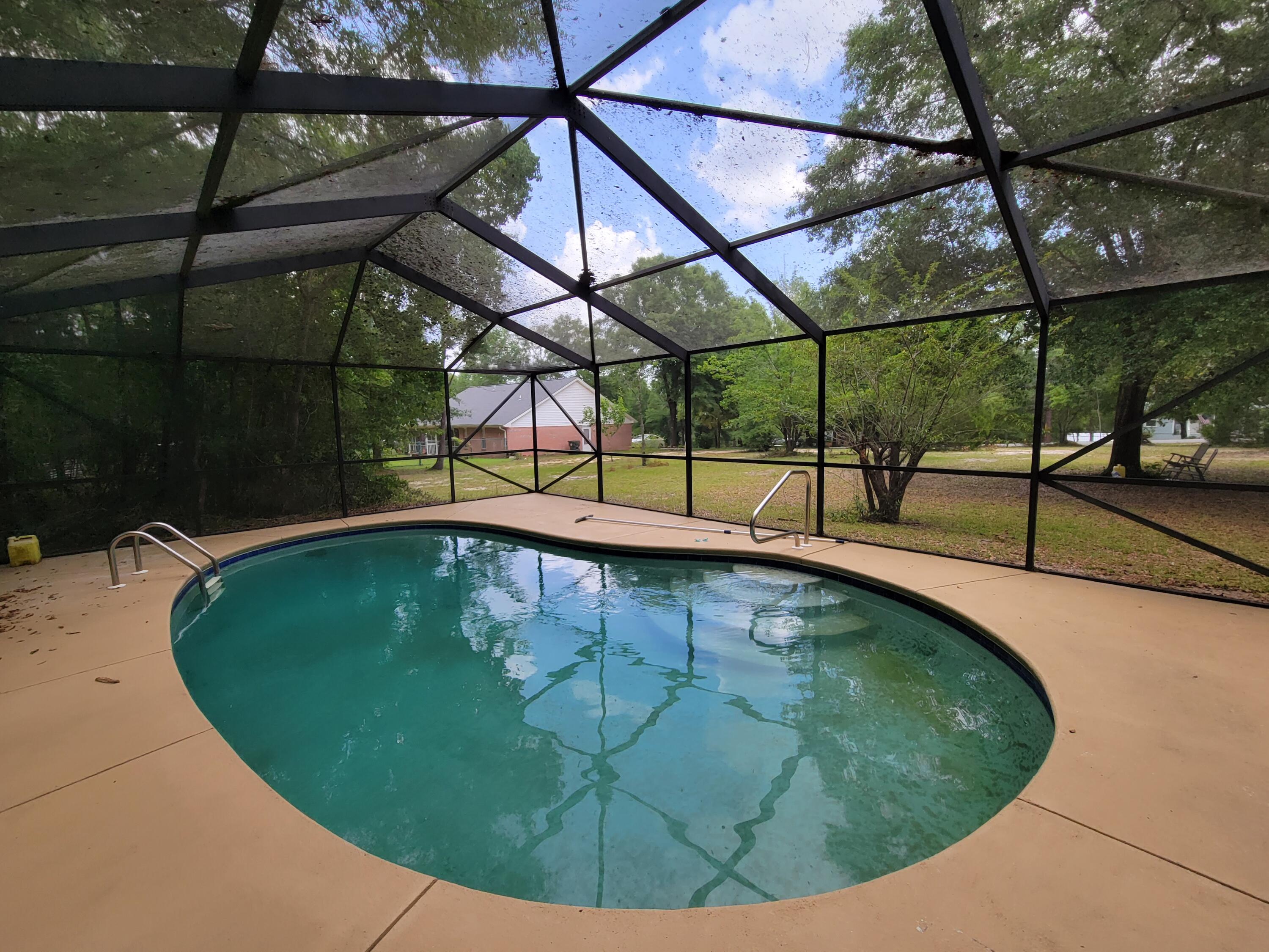 45 Hidden Lakes Trail DeFuniak Springs, FL 32433 - Photo 4 of 39 a view of a swimming pool with a patio and sitting area