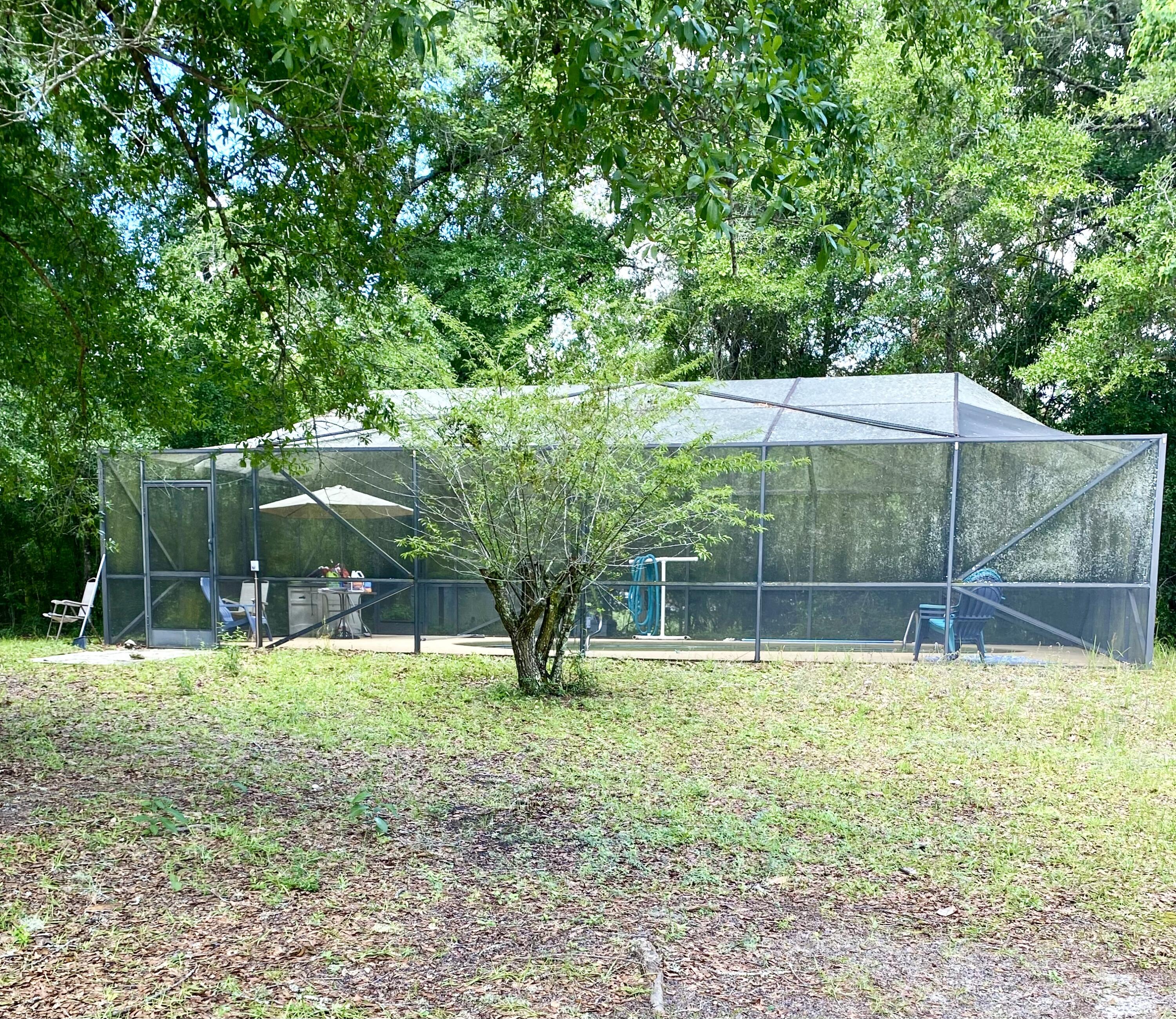 45 Hidden Lakes Trail DeFuniak Springs, FL 32433 - Photo 6 of 39 a swimming pool with outdoor seating and yard